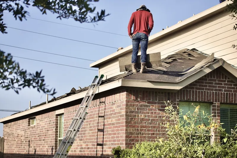 Professional roofer working on a residential roof in Village of Brushy Creek